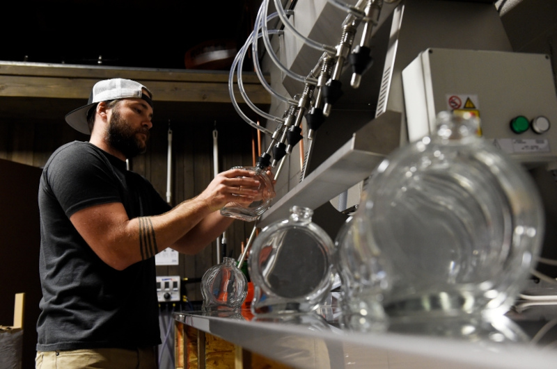 The bartender pours a drink